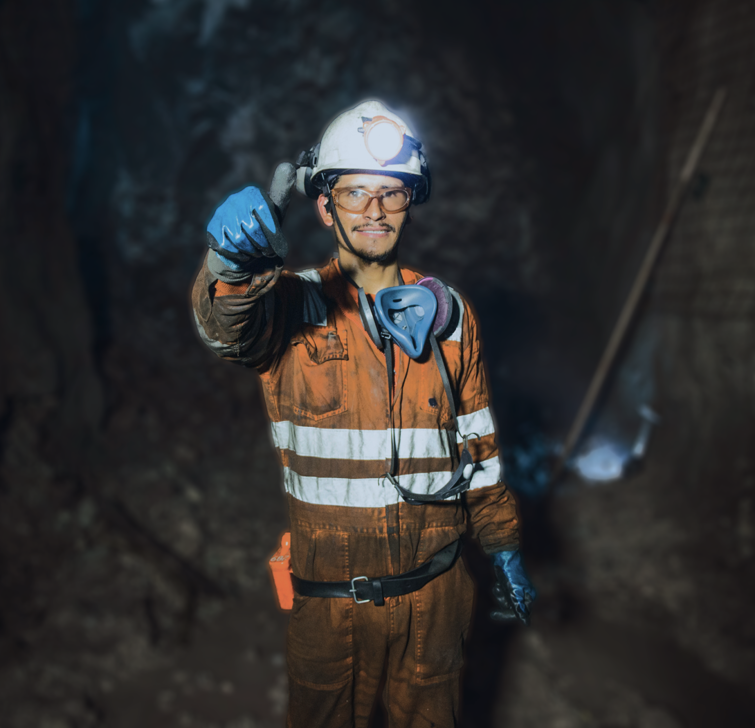 Mine worker smiling and showing a thumbs-up in an underground mine